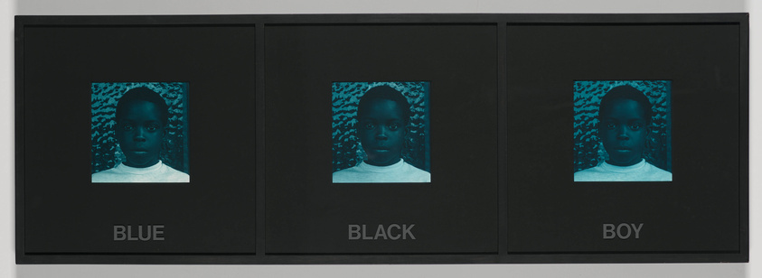 A triptych of framed images featuring the same portrait of a young boy in a cyanotype blue color. Each frame has a word at the bottom: "BLUE," "BLACK," and "BOY," respectively, from left to right. The background of each portrait has a patterned texture.