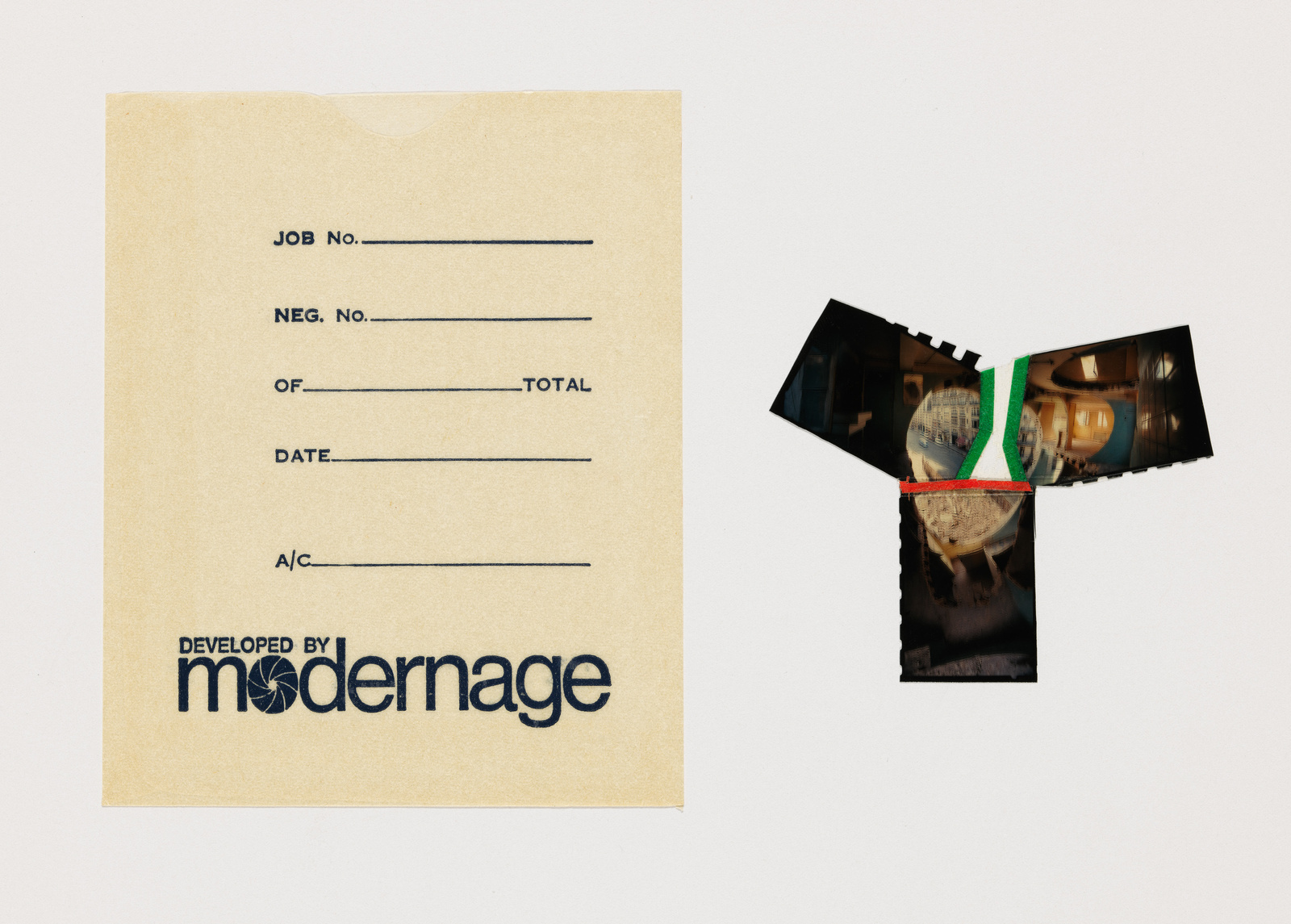 A vintage photo development envelope with text fields for job and negative numbers, and a torn photograph with indiscernible content next to it, both on a white background. The envelope is branded with "DEVELOPED BY MODERNAGE."
