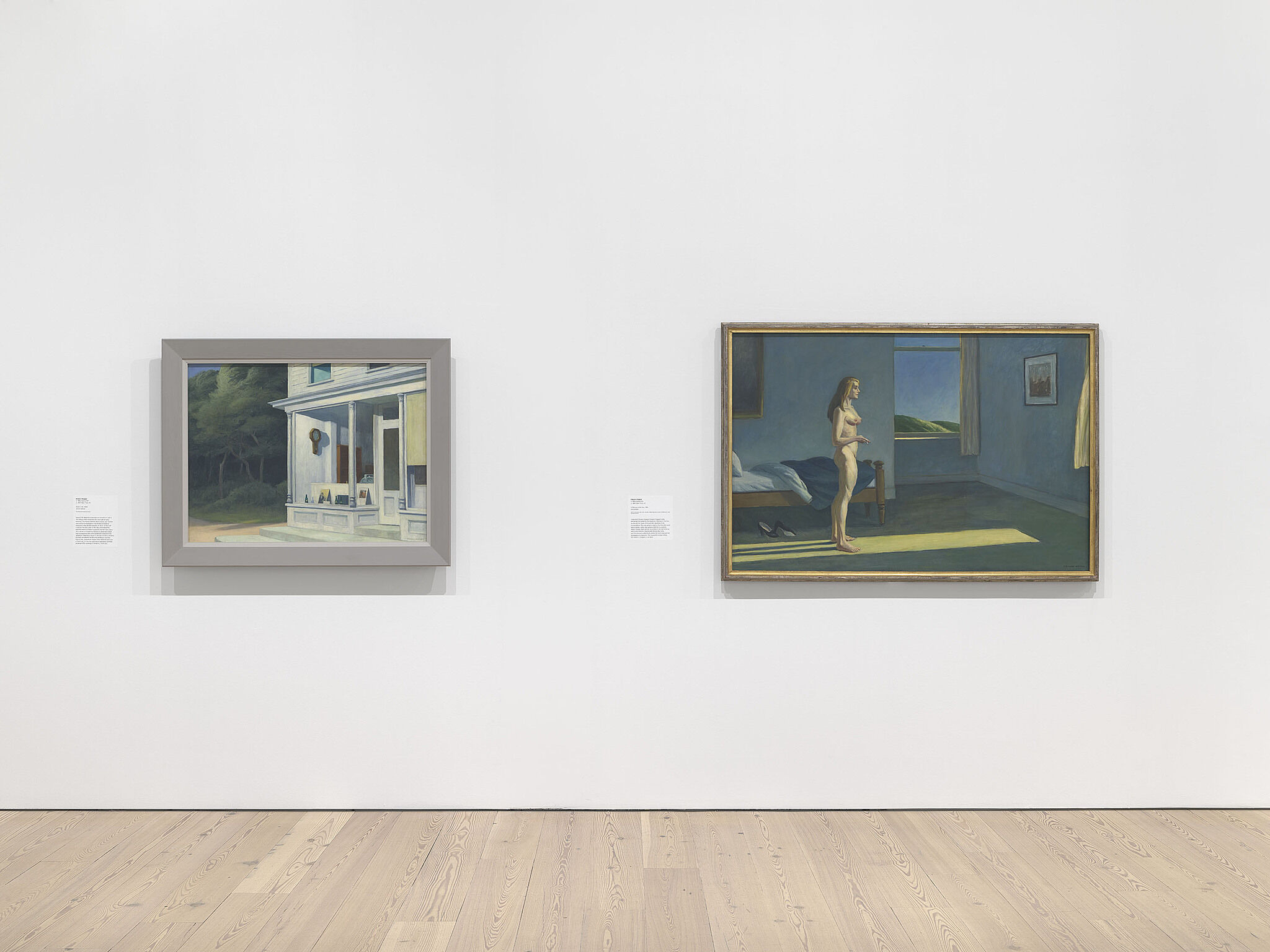 An image of the Whitney galleries with two paintings on the wall
