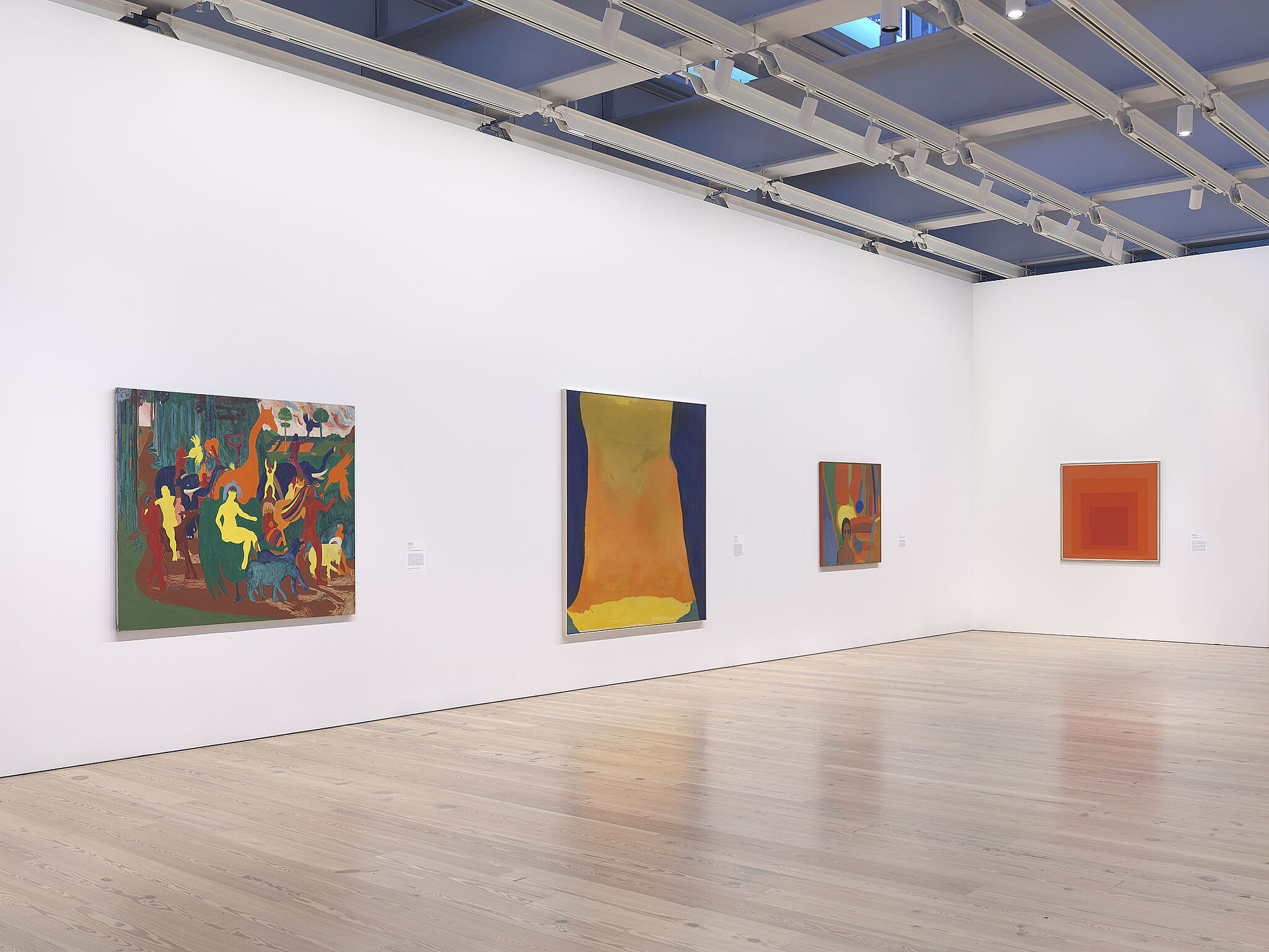 An image of the Whitney galleries with paintings on the wall