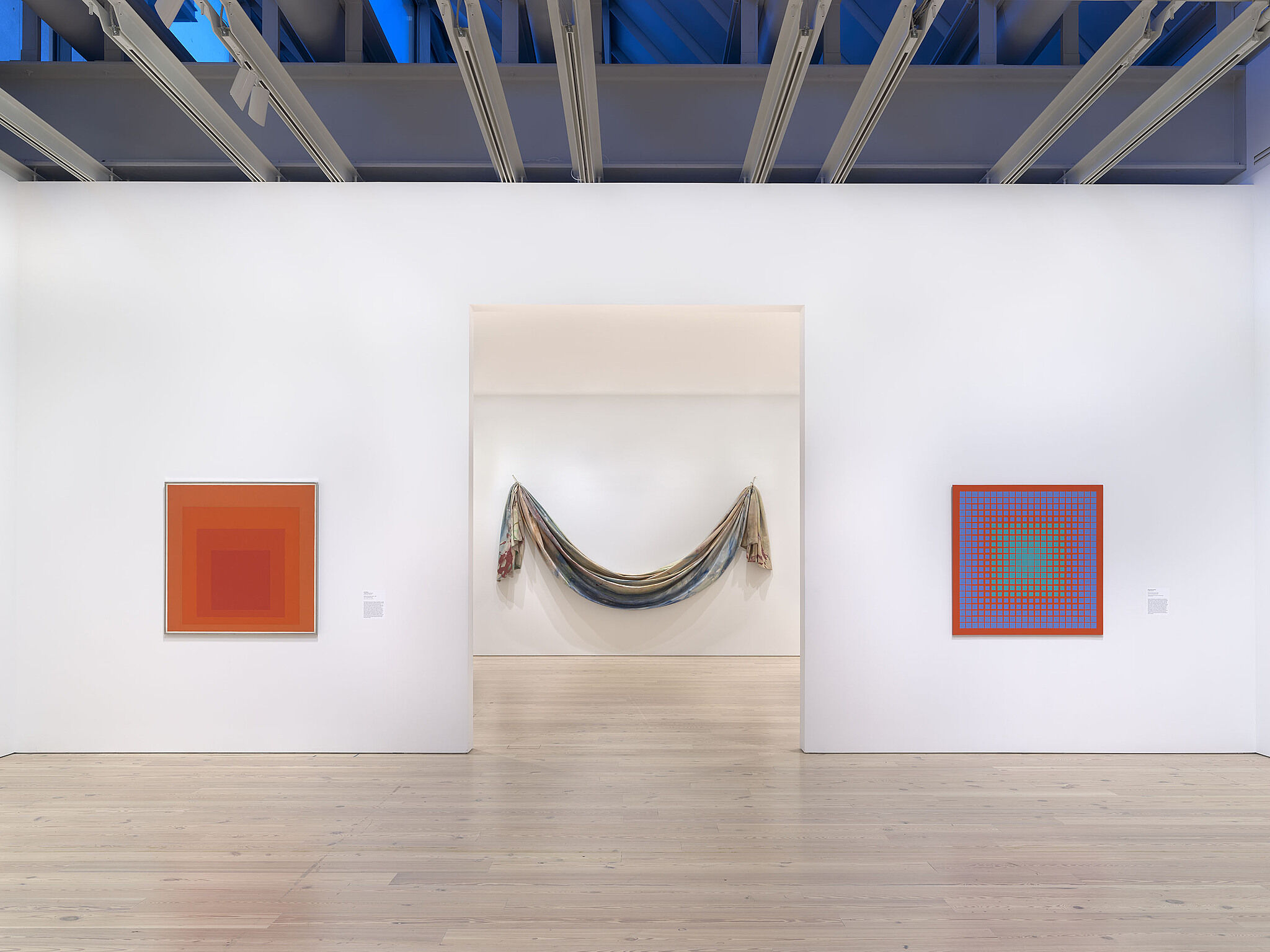 An image of the Whitney galleries with paintings on the wall