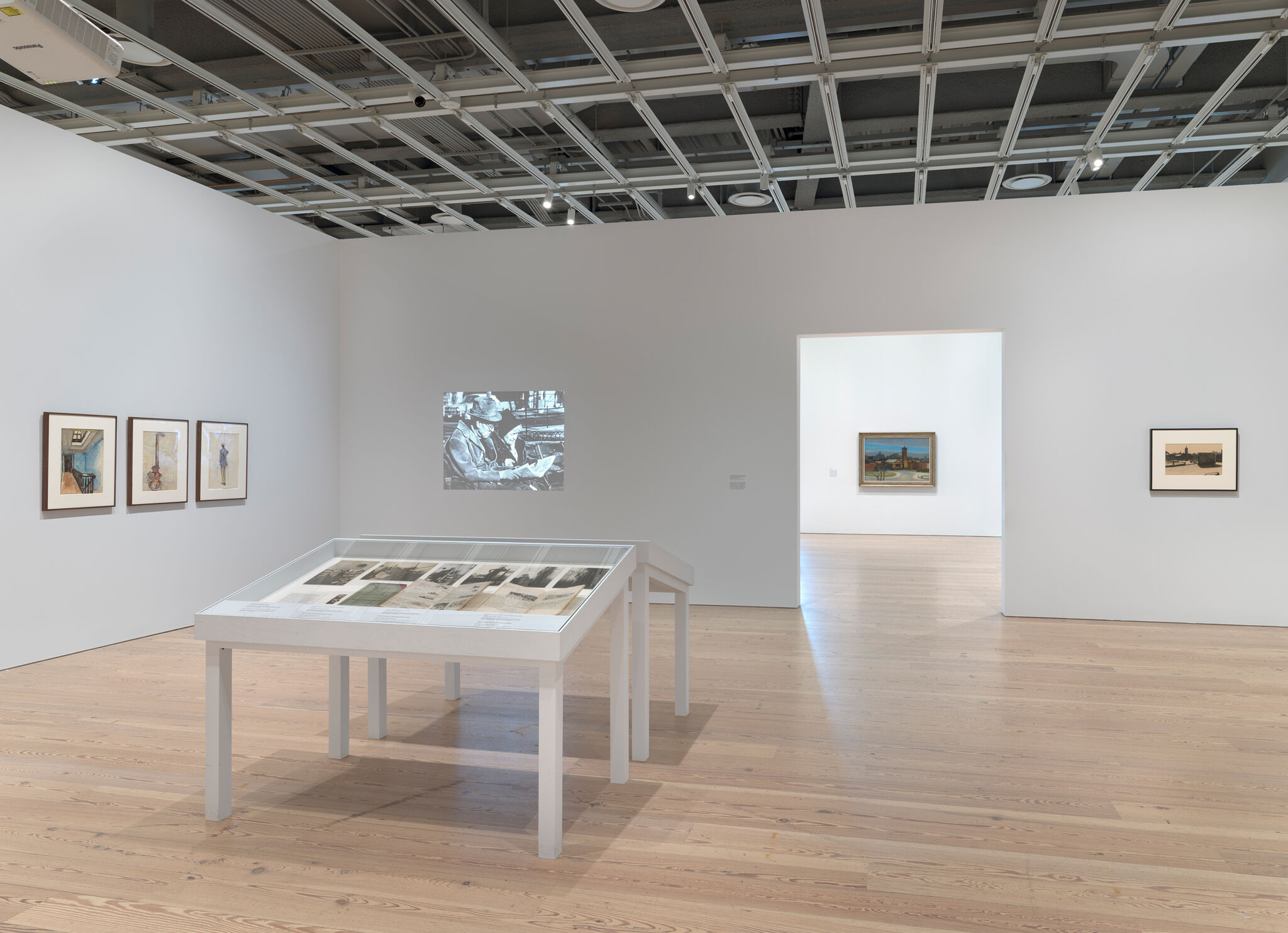 Multiple artwork in a light-filled gallery.